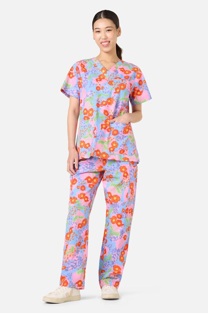 Image of a model wearing Uniforms & Workwear. Product name - Poppy Dotty Scrub Set in Multi colour by brand - Gorman