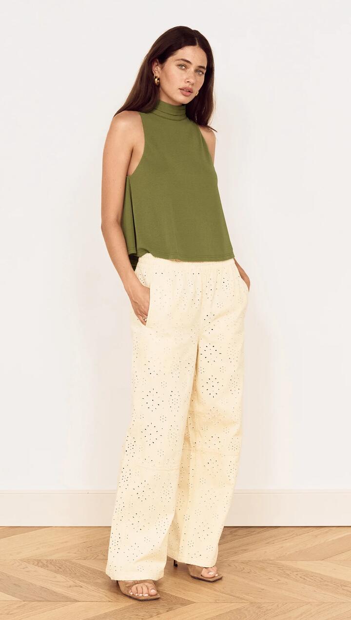 Image of a model wearing Tops. Product name - Green High Neck Jersey Top in Khaki colour by brand - MINKPINK