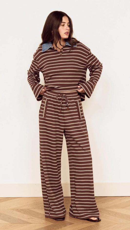 Image of a model wearing Tops. Product name - Stripe Relaxed Drawstring Jersey Pant in Chocolate Stripe colour by brand - MINKPINK