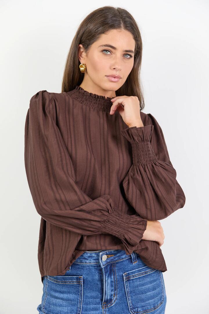 Image of a model wearing Tops. Product name - Embrace Chocolate Self Stripe Shirred Neck LS Top in Chocolate Self Stripe colour by brand - Among the Brave