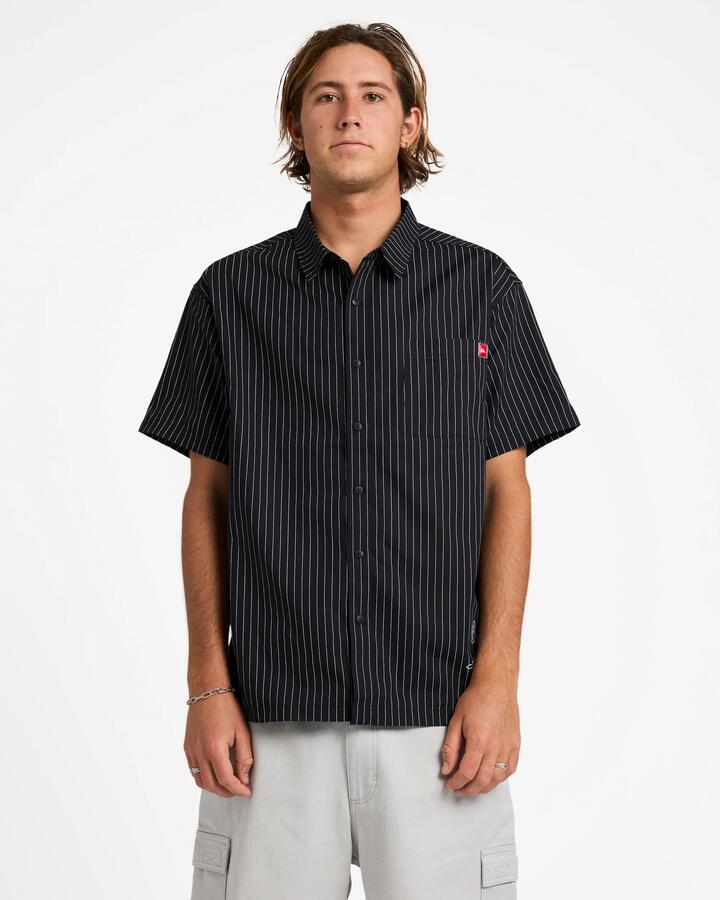 Image of a model wearing Tops. Product name - Quiksilver Mens Altered Short Sleeve Shirt Black in Black colour by brand - Quiksilver