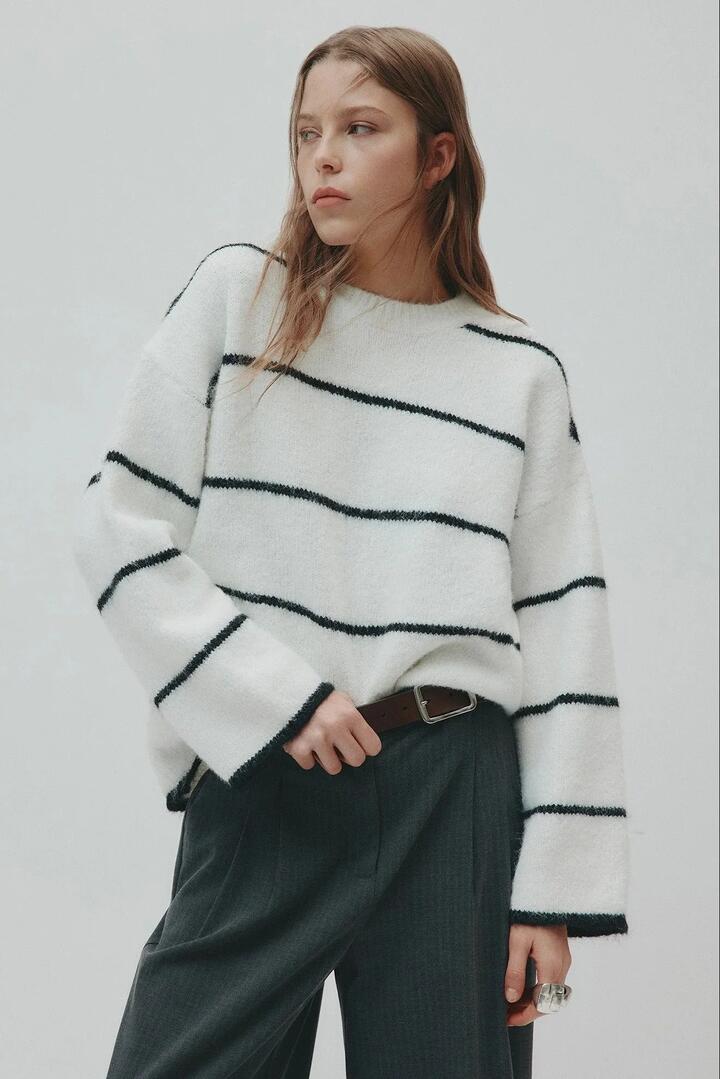 Image of a model wearing Outerwear. Product name - Colter Ivory Black Stripe Crew Knit in Ivory colour by brand - Nude Lucy