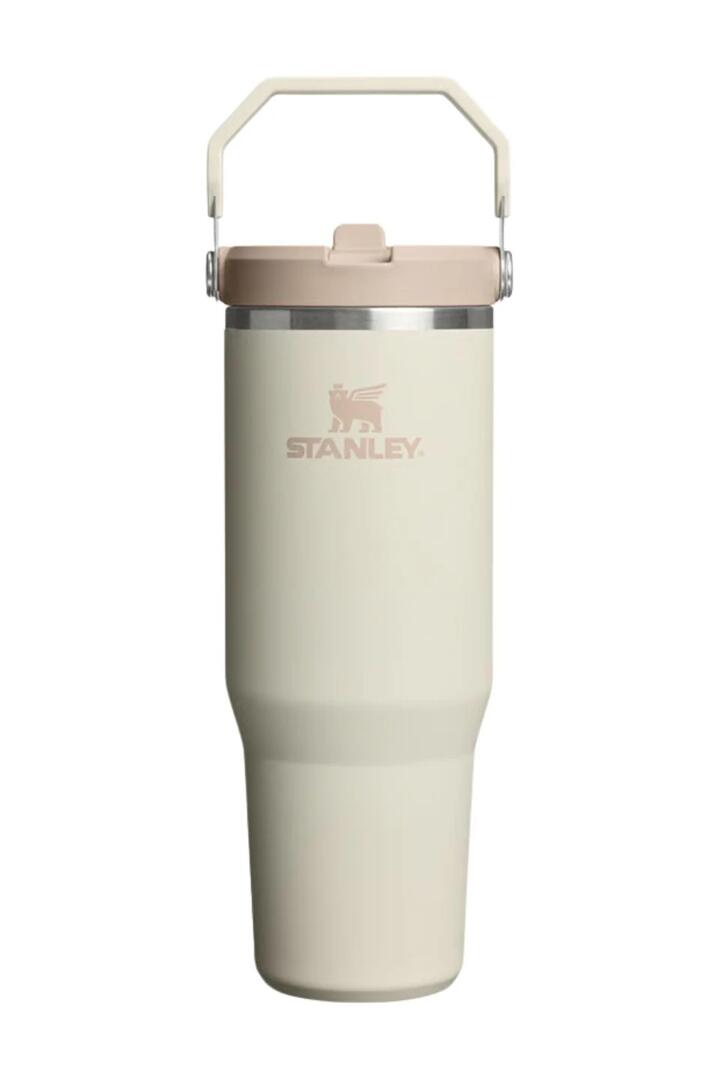 Image of a model wearing Tops. Product name - IceFlow Cream Flip Straw Top Handle 887ml 2.0 Tumbler in Cream colour by brand - Stanley