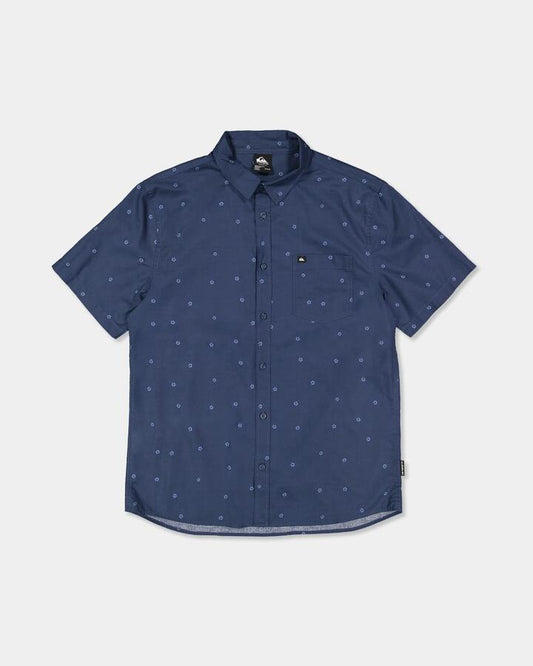 Image of a model wearing Tops. Product name - Quiksilver Mens Apero Classic Short Sleeve Shirt Dark Denm Ditsy Hibiscus Wove in Dark Denm Ditsy Hibiscus Wove colour by brand - Quiksilver