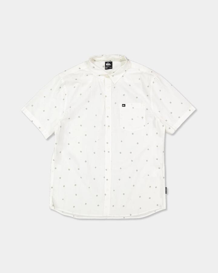 Image of a model wearing Tops. Product name - Quiksilver Mens Apero Classic Short Sleeve Shirt Snow White Ditsy Hibiscus Wove in Snow White Ditsy Hibiscus Wove colour by brand - Quiksilver