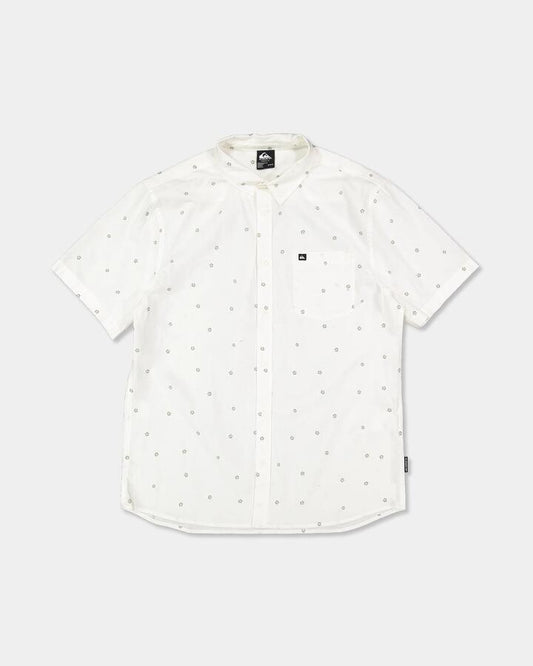 Image of a model wearing Tops. Product name - Quiksilver Mens Apero Classic Short Sleeve Shirt Snow White Ditsy Hibiscus Wove in Snow White Ditsy Hibiscus Wove colour by brand - Quiksilver