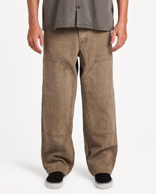 Image of a model wearing Pants. Product name - Volcom Mens Work Carpenter Pants Earth in Earth colour by brand - Volcom