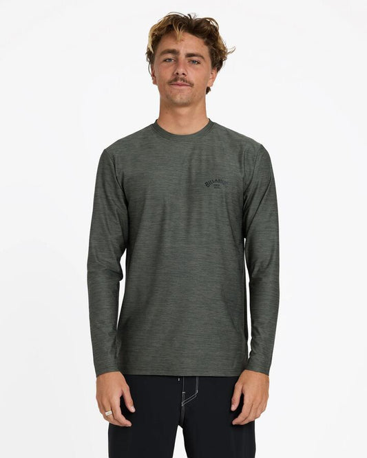 Image of a model wearing Tops. Product name - Billabong Mens Shoreline Loose Fit Long Sleeve Rash Vest Military Heather in Military Heather colour by brand - Billabong