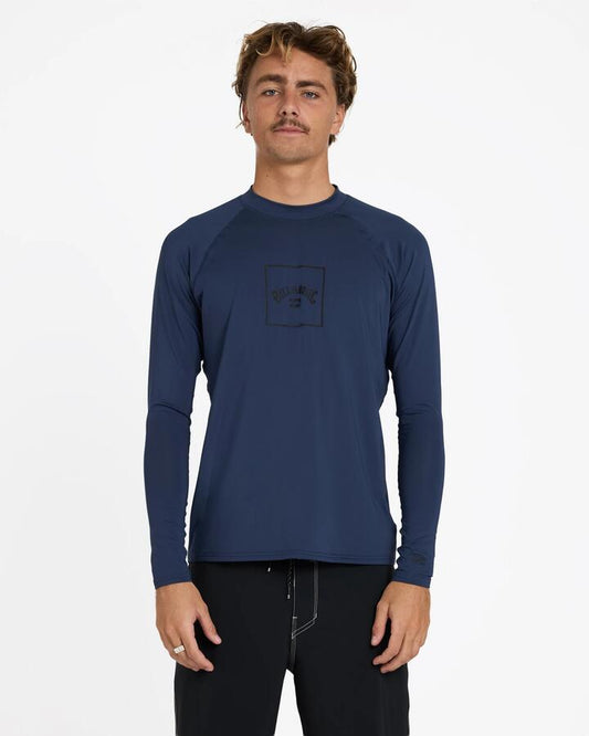 Image of a model wearing Tops. Product name - Billabong Mens Boxed Arch Long Sleeve Rash Vest Dusty Navy in Dusty Navy colour by brand - Billabong