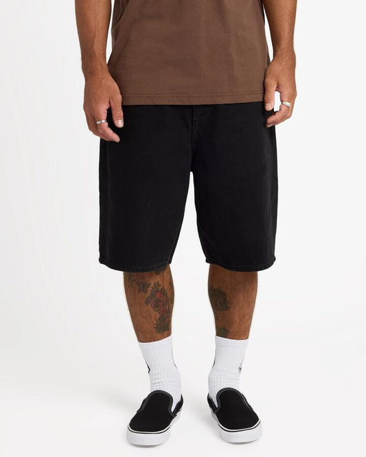 Image of a model wearing Shorts. Product name - Volcom Mens Billow 2 Denim Shorts 22" Black in Black colour by brand - Volcom