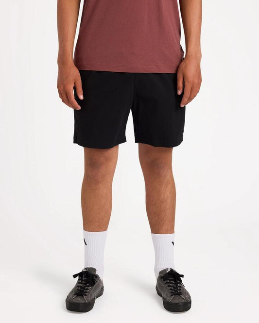 Image of a model wearing Shorts. Product name - Rvca Mens Escape 17" Elastic Waist Shorts Black in Black colour by brand - Rvca