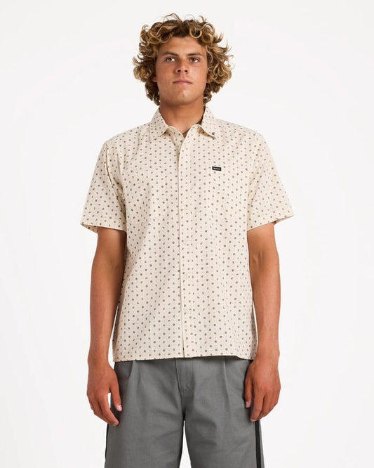Image of a model wearing Tops. Product name - Rvca Mens Breezy Short Sleeve Shirt Ceramic in Ceramic colour by brand - Rvca