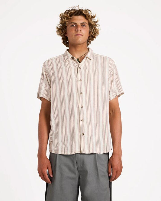 Image of a model wearing Tops. Product name - Rvca Mens Beat Stripe Short Sleeve Shirt Natural in Natural colour by brand - Rvca