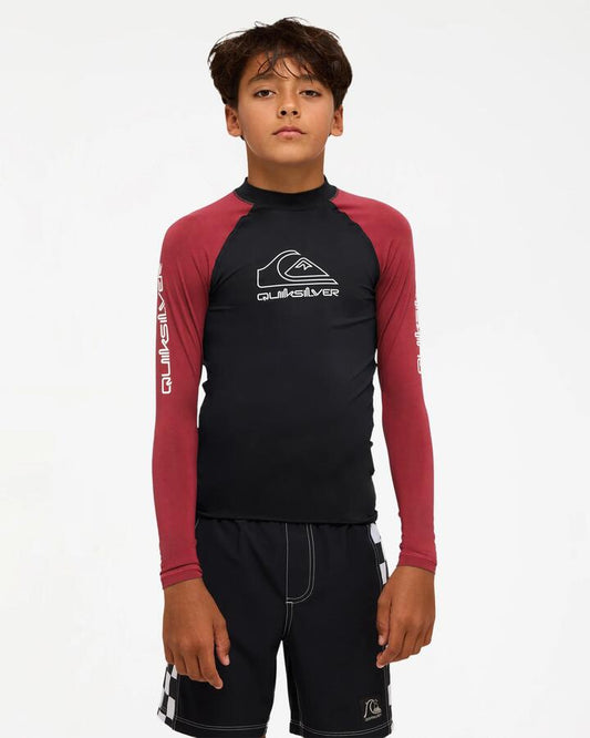 Image of a model wearing Tops. Product name - Quiksilver Boys 8-16 On Tour Long Sleeve Rash Vest Burnt Russet in Burnt Russet colour by brand - Quiksilver