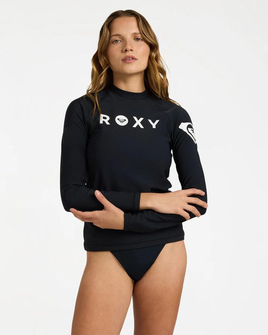Image of a model wearing Tops. Product name - Roxy Womens Essentials Upf 50 Long Sleeve Heater Rashguard Anthracite in Anthracite colour by brand - Roxy