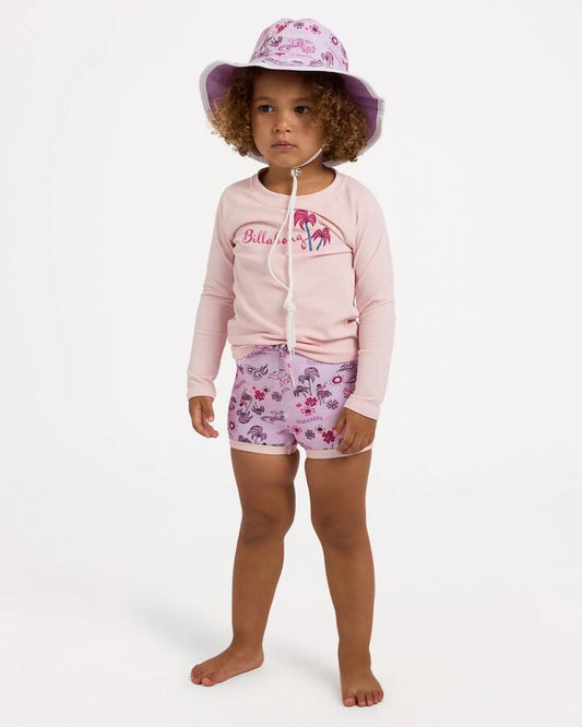 Image of a model wearing Tops. Product name - Billabong Girls 0-5 Hula Haze Long Sleeve Rash Vest Magnolia in Magnolia colour by brand - Billabong