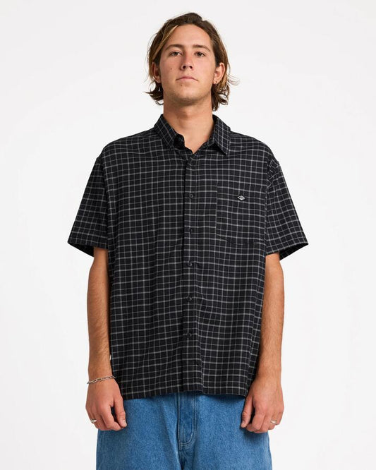 Image of a model wearing Tops. Product name - Quiksilver Mens Liquid Short Sleeve Shirt Black in Black colour by brand - Quiksilver