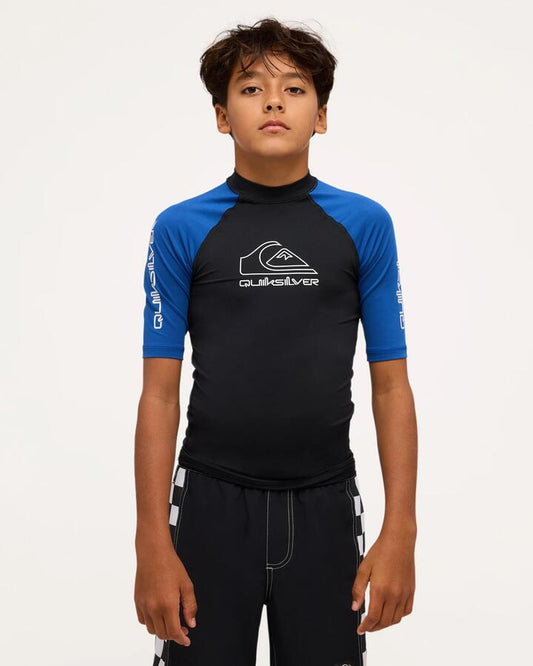 Image of a model wearing Tops. Product name - Quiksilver Boya 8-16 On Tour Short Sleeve Rash Vest Monaco Blue in Monaco Blue colour by brand - Quiksilver