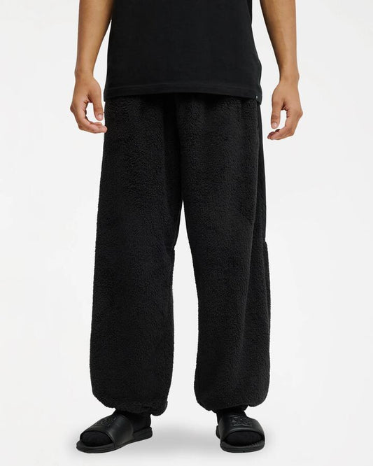 Image of a model wearing Outerwear. Product name - DC Shoes Mens Lynx Fleece Sweatpants Anthracite in Anthracite colour by brand - DC Shoes