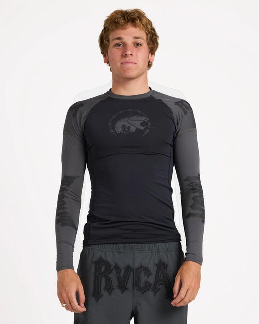 Image of a model wearing Tops. Product name - Rvca Mens Tapout Long Sleeve Rashguard Black in Black colour by brand - Rvca