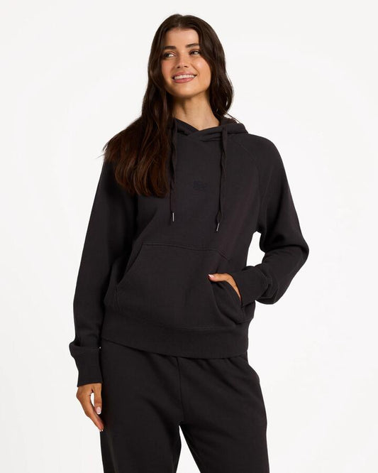 Image of a model wearing Outerwear. Product name - Billabong Womens Wave Essentials Pullover Hoodie Off Black in Off Black colour by brand - Billabong