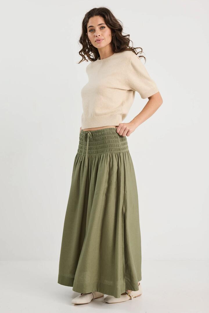 Image of a model wearing Skirts. Product name - Byron Olive Linen Shirred Waist Maxi Skirt in Olive colour by brand - RE:UNION Label
