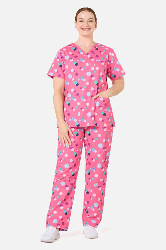 Image of a model wearing Uniforms & Workwear. Product name - Polka Dots Scrub Set in Pink colour by brand - Scrubs With Love