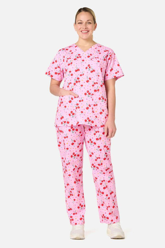 Image of a model wearing Uniforms & Workwear. Product name - Cherry Stars Scrub Set in Pink colour by brand - Scrubs With Love