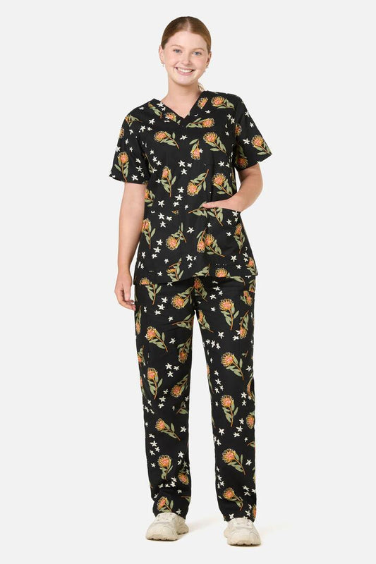 Image of a model wearing Uniforms & Workwear. Product name - Pincushion Protea Scrub Set in Black colour by brand - Scrubs With Love