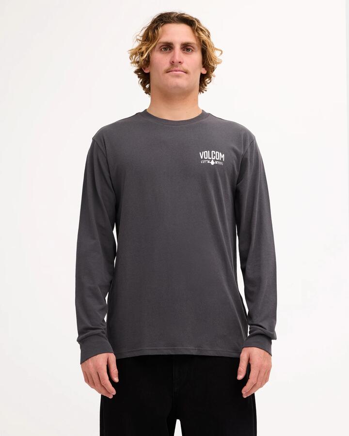 Image of a model wearing Tops. Product name - Volcom Mens Carbide Long Sleeve T-Shirt Asphalt Black in Asphalt Black colour by brand - Volcom
