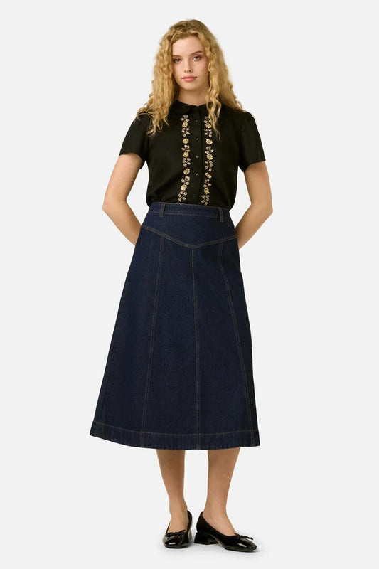Image of a model wearing Skirts. Product name - Olinda Denim Midi Skirt in Blue Denim colour by brand - Princess Highway