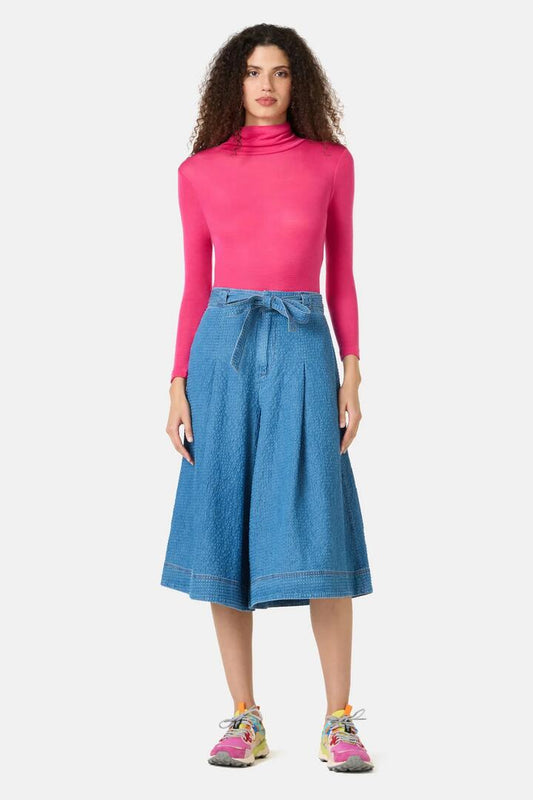 Image of a model wearing Skirts. Product name - Daphne Seersucker Denim Skort in Mid Blue colour by brand - Gorman