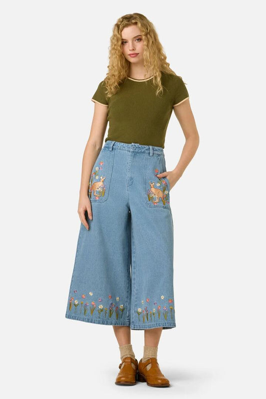 Image of a model wearing Pants. Product name - Kangaroo Embroidered Culotte in Blue Denim colour by brand - Princess Highway