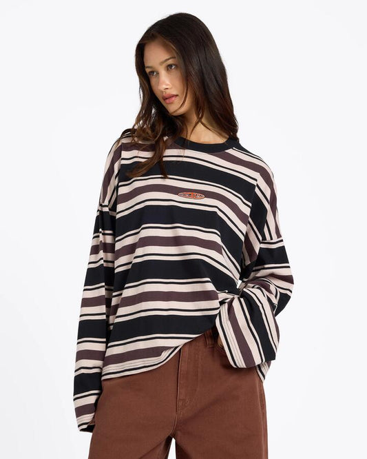Image of a model wearing Tops. Product name - Volcom Womens Triptronic Long Sleeve T-Shirt Raisin in Raisin colour by brand - Volcom