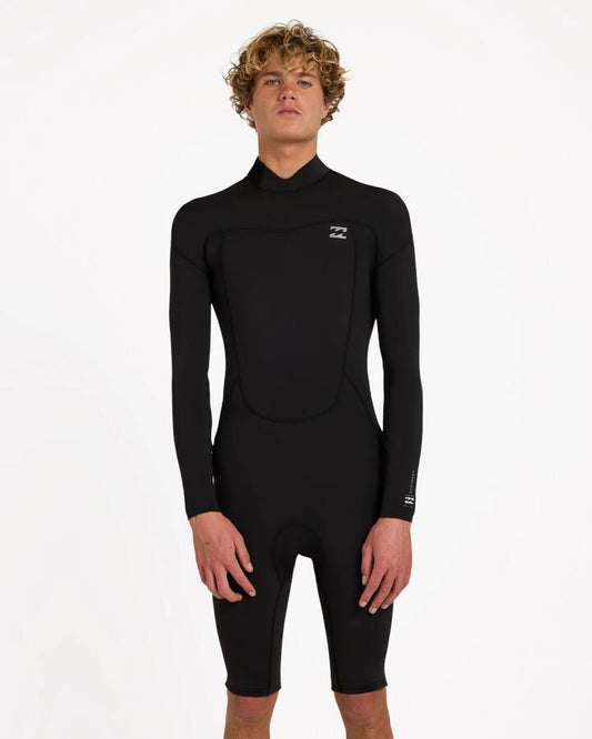 Image of a model wearing Tops. Product name - Billabong Mens 2/2 Absolute Long Sleeve Springsuit Black in Black colour by brand - Billabong