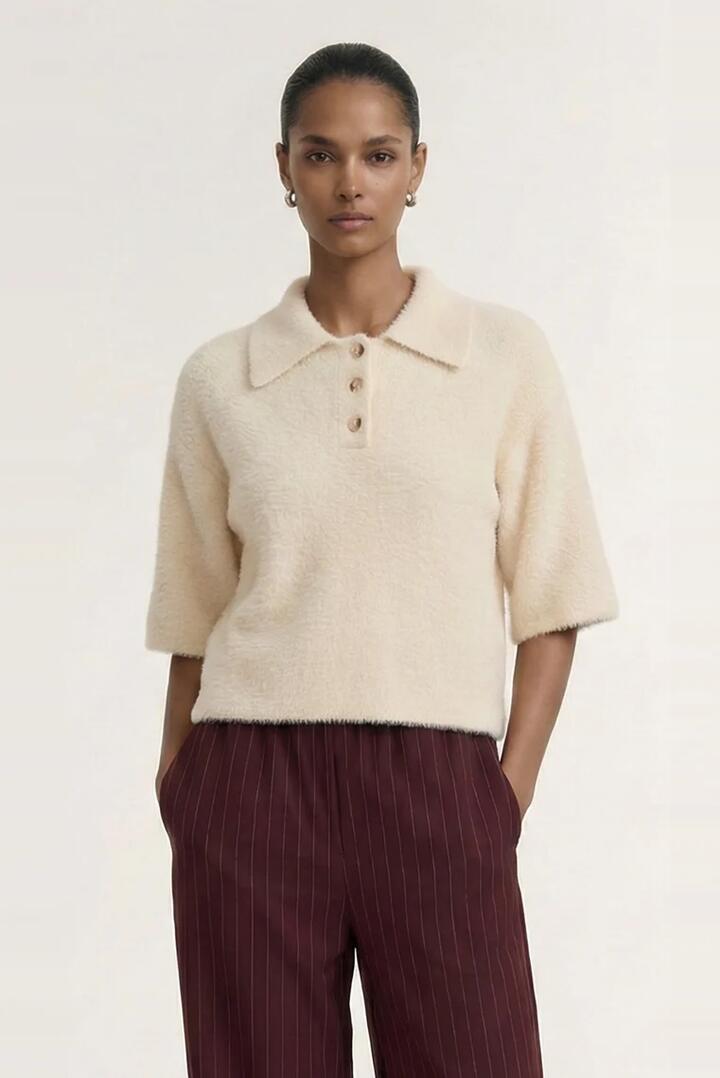 Image of a model wearing Outerwear. Product name - Celine Natural Beige Polo SS Knit Top in Natural colour by brand - Staple The Label