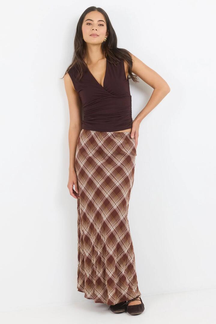 Image of a model wearing Skirts. Product name - Breathe Brown Check Bias Maxi Skirt in Brown Check colour by brand - Stories be Told