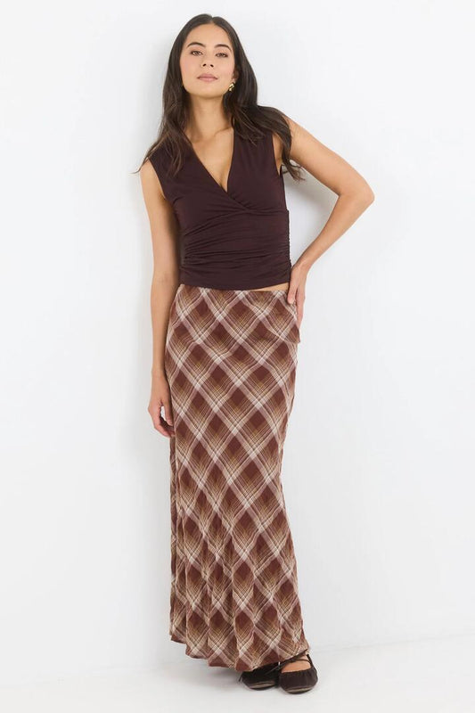 Image of a model wearing Skirts. Product name - Breathe Brown Check Bias Maxi Skirt in Brown Check colour by brand - Stories be Told