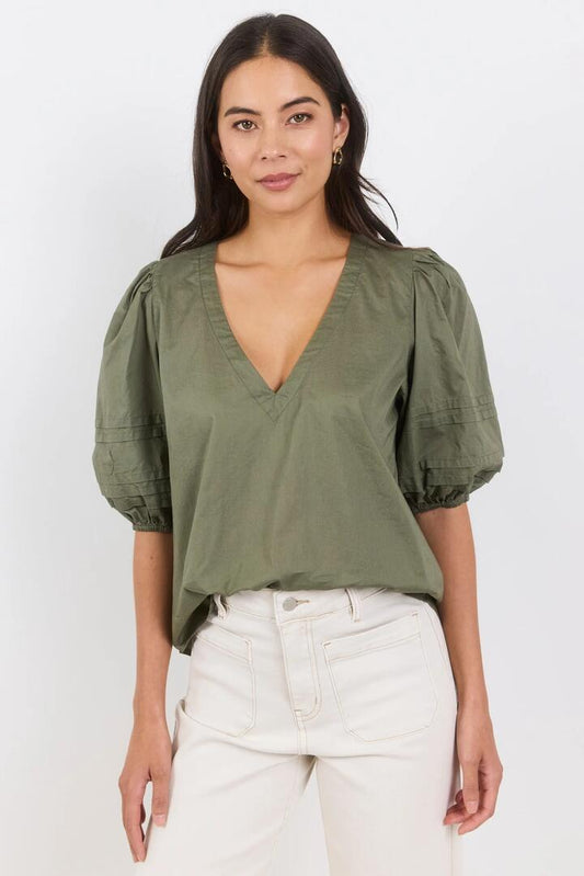 Image of a model wearing Tops. Product name - Recall Sage Pleat Short Sleeve Top in Sage colour by brand - Ivy + Jack