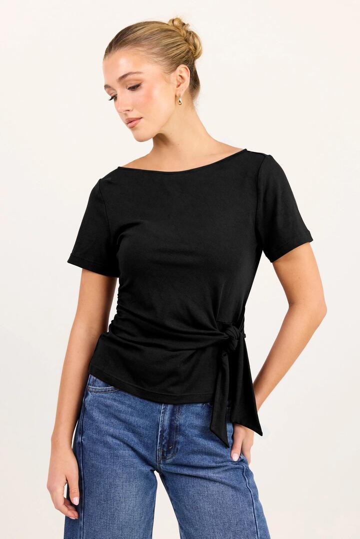 Image of a model wearing Tops. Product name - Turn Black Boat Neck Knot Front Short Sleeve Tee in Black colour by brand - Among the Brave