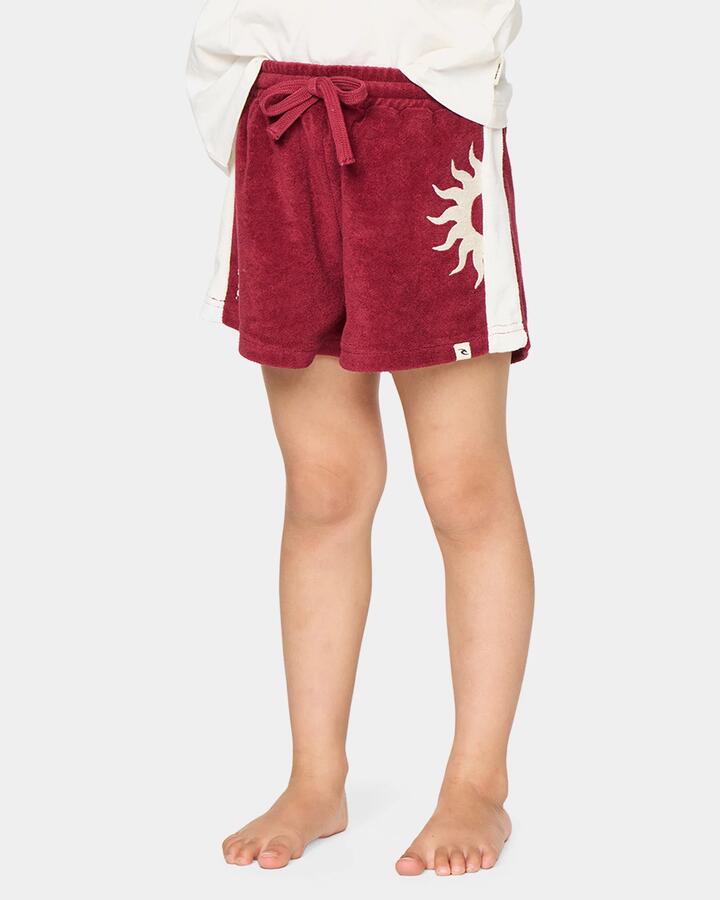Image of a model wearing Shorts. Product name - Rip Curl Girls 2-7 Road Trip Terry Shorts Plum in Plum colour by brand - Rip Curl