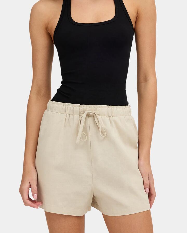 Image of a model wearing Shorts. Product name - Nunui Womens Roam Elastic Waist Shorts Natural in Natural colour by brand - Nunui