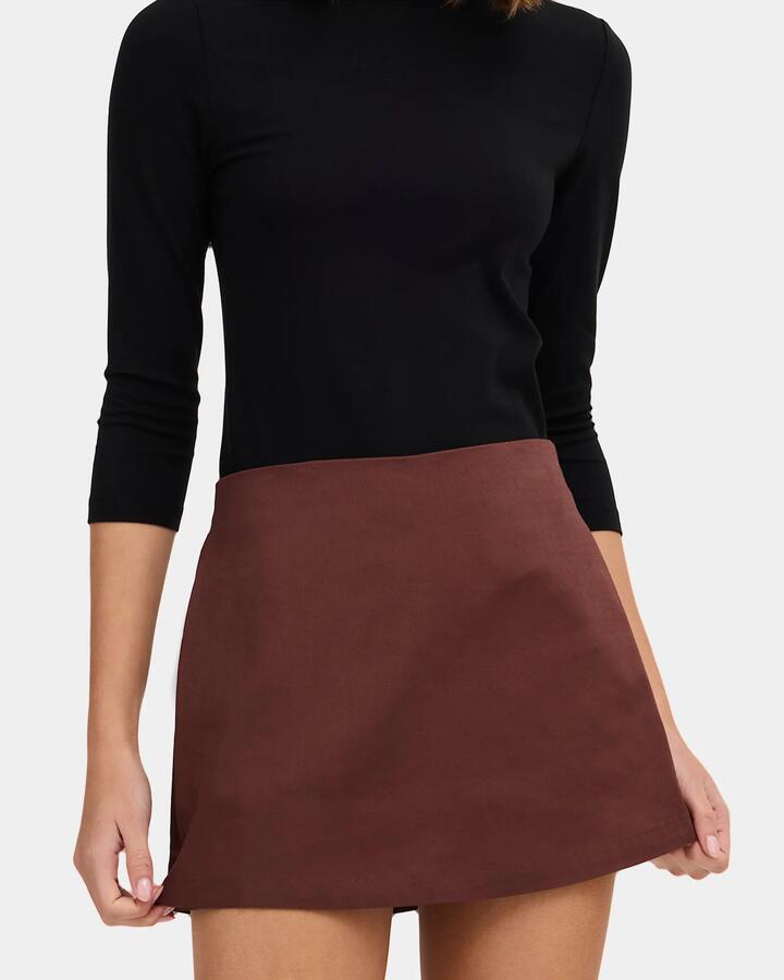 Image of a model wearing Skirts. Product name - Nunui Womens Slay Skort Chocolate in Chocolate colour by brand - Nunui