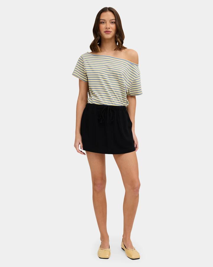 Image of a model wearing Skirts. Product name - Nunui Womens Anya Mini Skirt Black in Black colour by brand - Nunui
