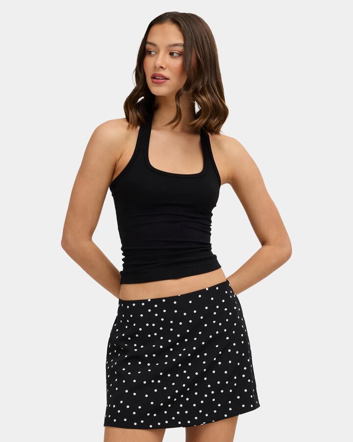 Image of a model wearing Tops. Product name - Nunui Womens Hug Me Halter Tank Top Black in Black colour by brand - Nunui