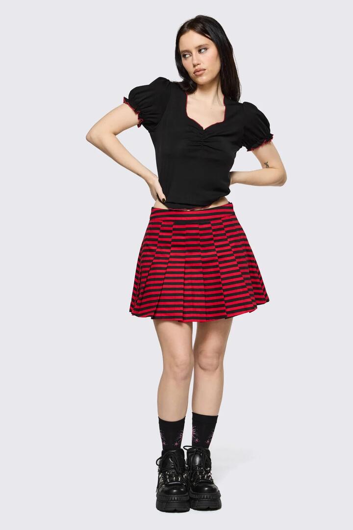 Image of a model wearing Skirts. Product name - Trad Emo Stripe Pleated Skirt in Black Red colour by brand - Black Friday