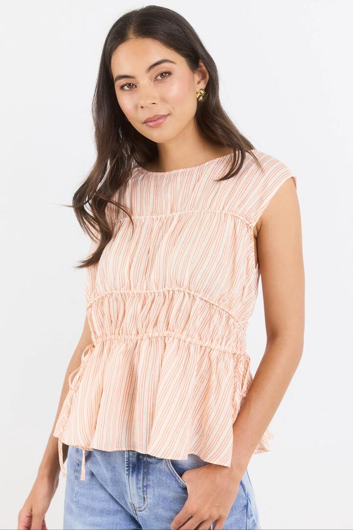 Image of a model wearing Tops. Product name - Context Blood Orange Stripe Relaxed Sleeveless Top in Blood Orange Stripe colour by brand - Stories be Told