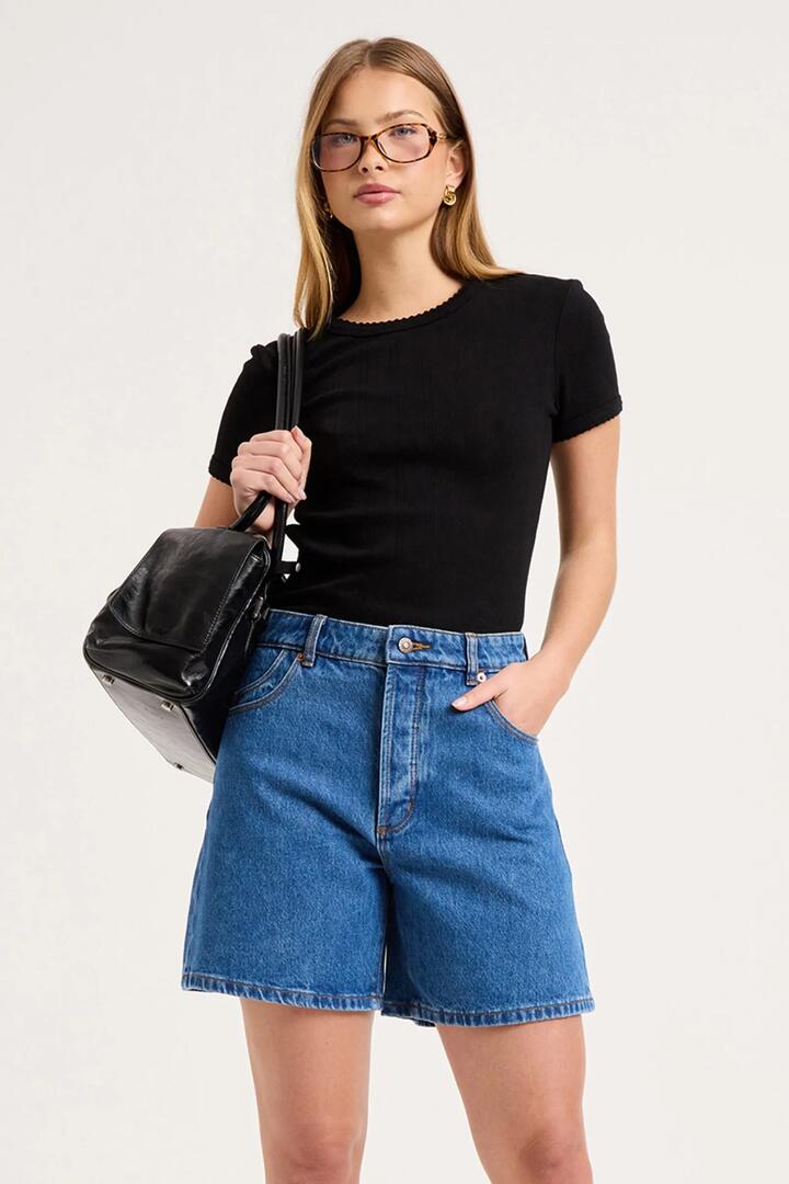 Image of a model wearing Shorts. Product name - 90s Relaxed Canyon Stone Blue Short in Blue colour by brand - Rollas