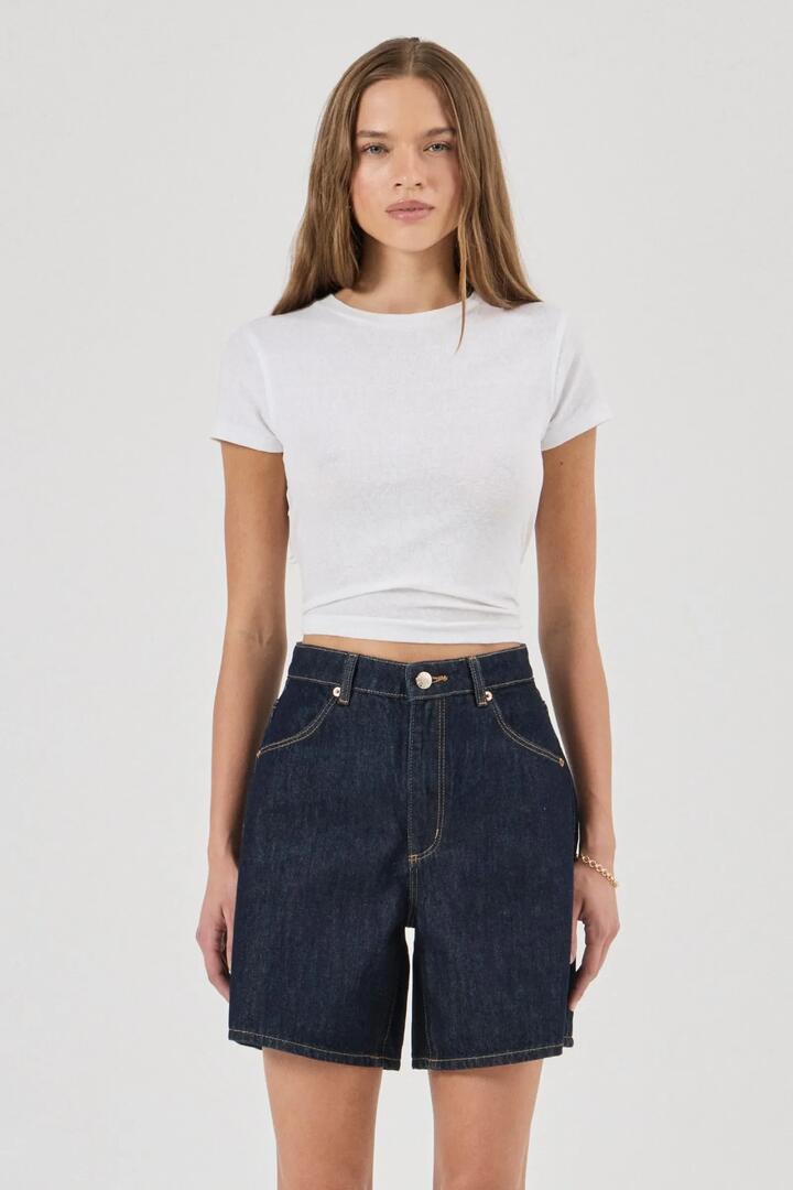 Image of a model wearing Shorts. Product name - Super Mirage Rinse Dark Denim Shorts in Blue colour by brand - Rollas
