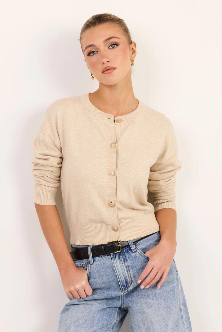Image of a model wearing Outerwear. Product name - Delight Champagne Cotton Cashmere Fine Knit Crew Cardigan in Champagne colour by brand - Ivy + Jack